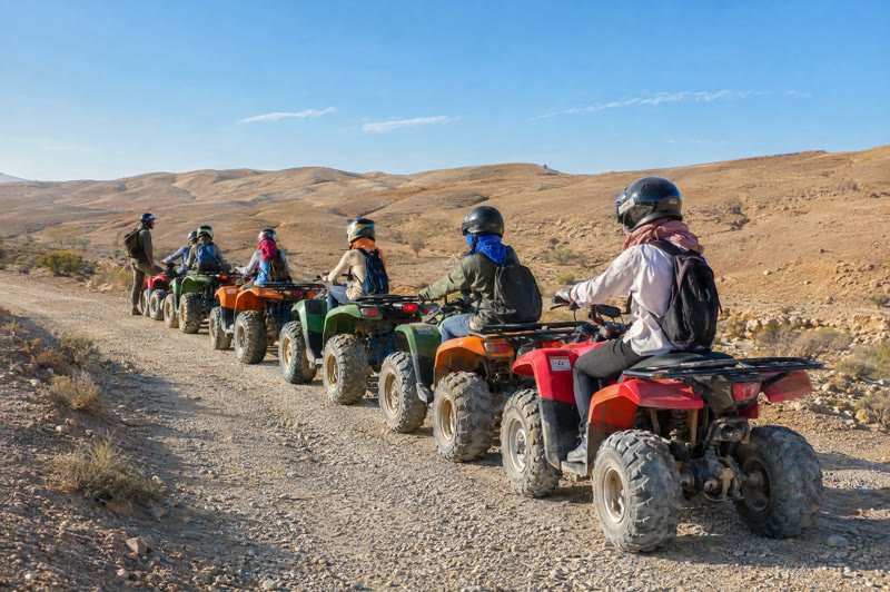 The quad group lined up on a gravel track, ready to ride